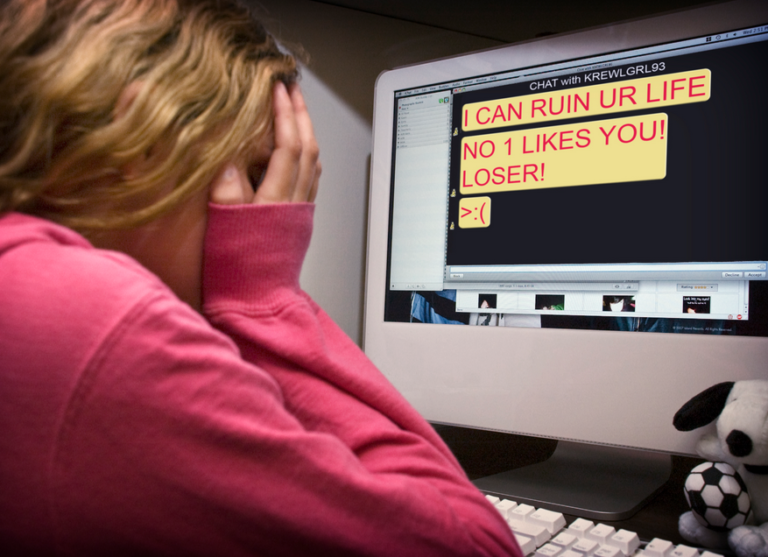 girl staring at computer that says "i can ruin your life no one likes you" cyber bullying