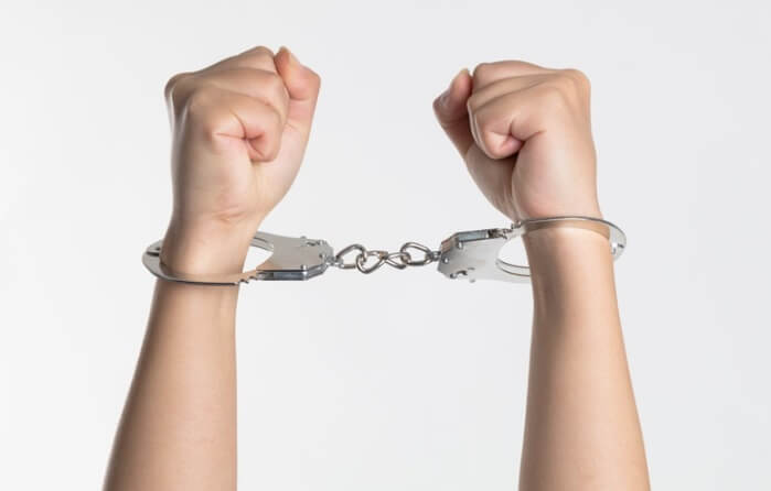 teen hands in handcuffs