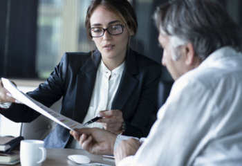 Man looking over documents with divorce attorney