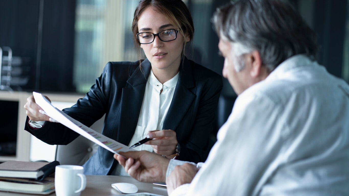 Man looking over documents with divorce attorney