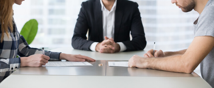 Man and woman signing an agreement together