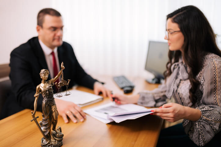 Woman sitting with divorce attorney