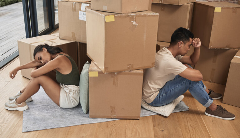 Young couple surrounded by moving boxes