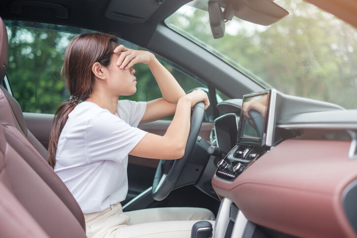 woman feeling stress and angry during drive car long time. Asian girl tired and fatigue having headache stop after driving car in traffic jam. Sleepy, stretching and drunk concept in north carolina