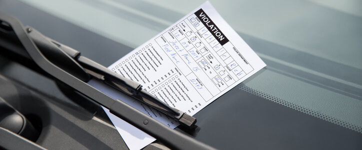 Close-up of parking ticket on car's windshield in nc