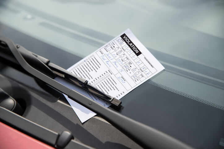 Close-up of parking ticket on car's windshield in nc