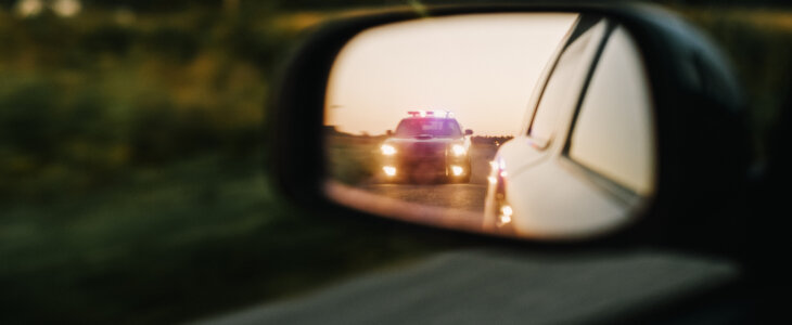 Stylish Side Mirror Car Chase Shot: Highway Traffic Patrol Vehicle Pull over Suspect. Professional Female Police Officer Approaches Vehicle, Asks Driver License and Registration. Cinematic Shot