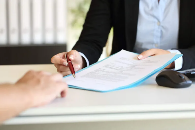 lawyer signing contract agreement with client